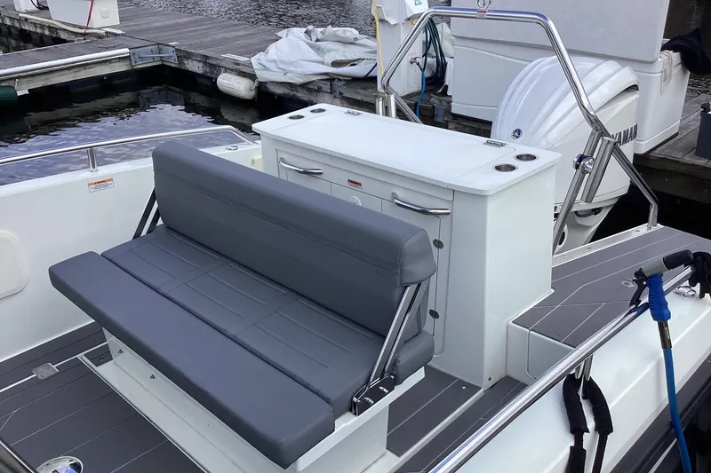Slide: The Image of 2024 Quarken 27 T-Top V2 boat interior with gray seating and console. - 38