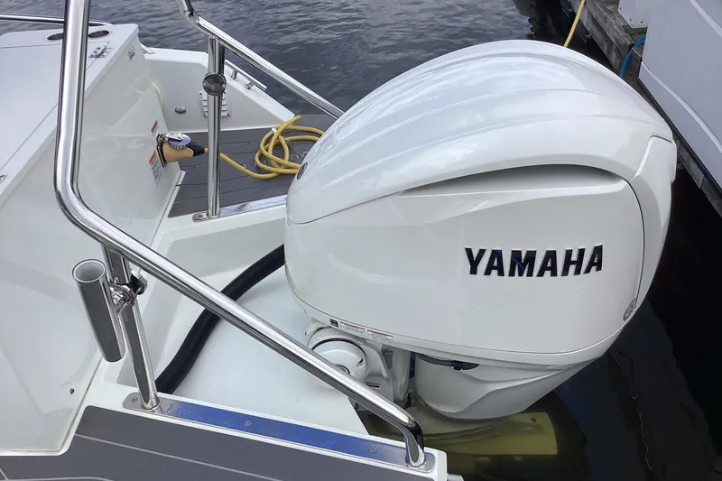 Slide: The Image of 2024 Quarken 27 T-Top V2 with Yamaha outboard engine at dockside. - 39