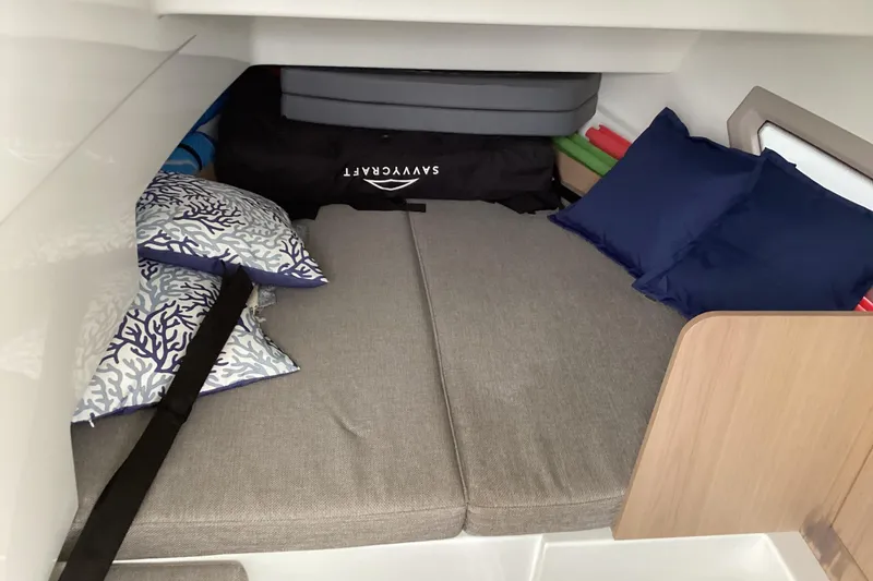 Slide: The Image of Cozy cabin interior of 2024 Quarken 27 T-Top V2 with cushions and storage. - 6