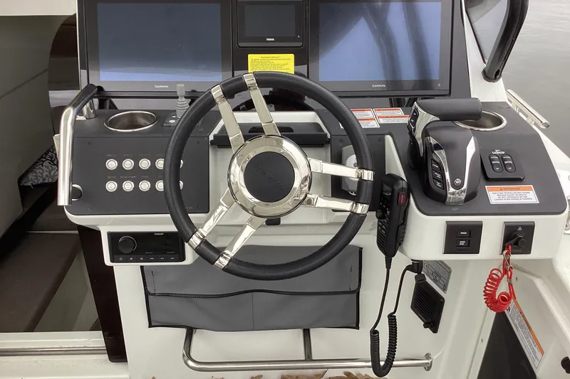 Slide: The Image of 2024 Quarken 27 T-Top V2 boat dashboard with steering wheel and controls. - 9