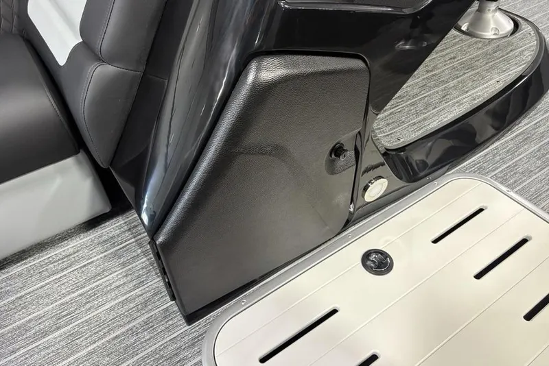 Slide: The Image of Interior of 2026 Premier 230 Sunsation RL boat, featuring sleek black and gray seating. - 16