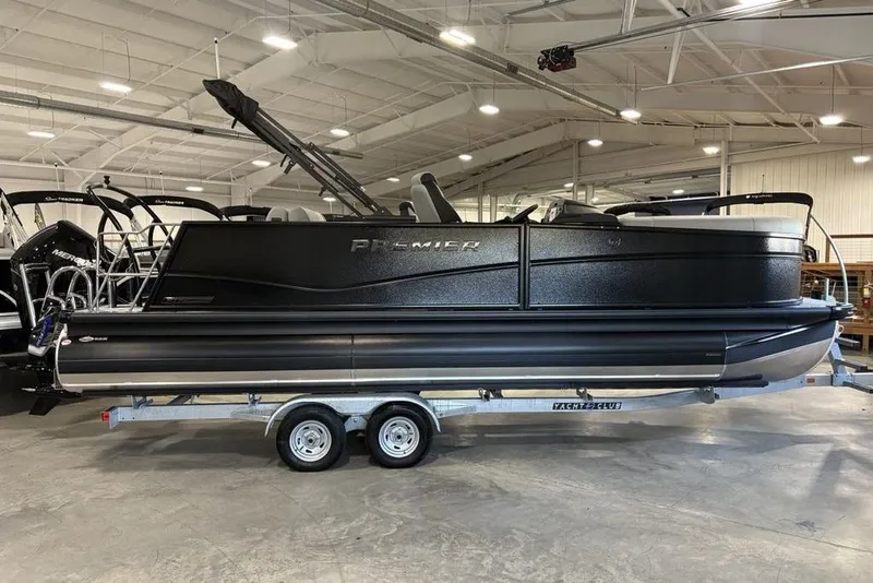 The Image of 2026 Premier 230 Sunsation RL pontoon boat on trailer in showroom. - 2