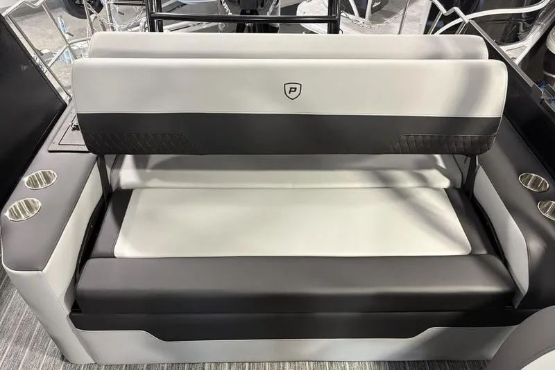 Slide: The Image of 2026 Premier 230 Sunsation RL boat seating with cup holders, featuring sleek black and white design. - 25