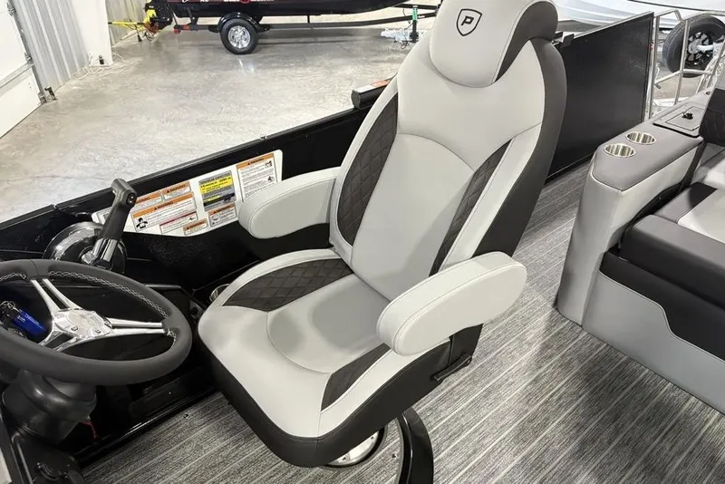 Slide: The Image of Captain's chair and steering wheel of 2026 Premier 230 Sunsation RL pontoon boat. - 26