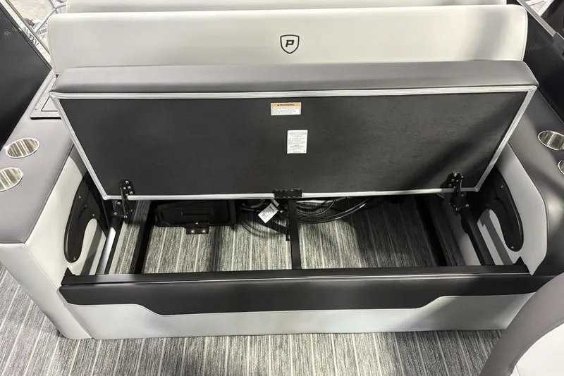 Slide: The Image of Open storage compartment in 2026 Premier 230 Sunsation RL boat, featuring sleek seating and cup holders. - 27