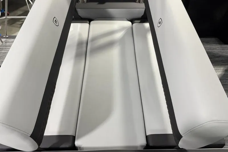 Slide: The Image of Interior seating of 2026 Premier 230 Sunsation RL pontoon boat, featuring sleek white upholstery. - 29