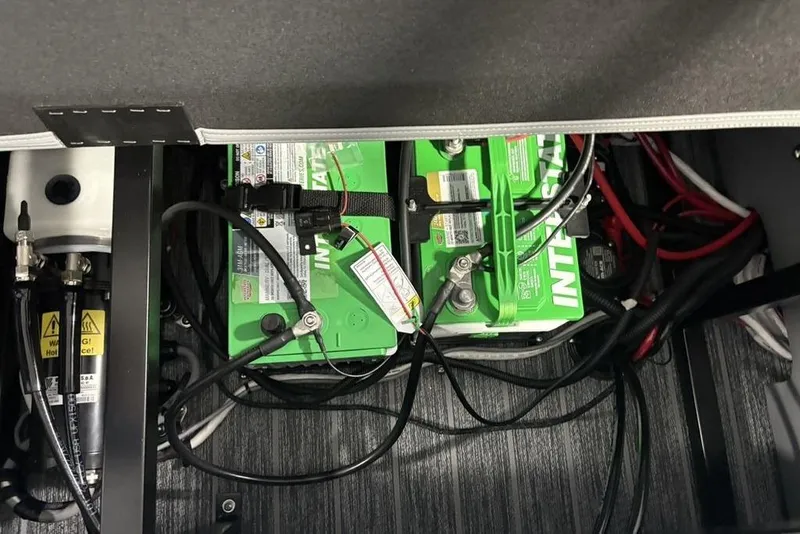 Slide: The Image of Battery compartment of 2026 Premier 230 Sunsation RL with wiring and components. - 32