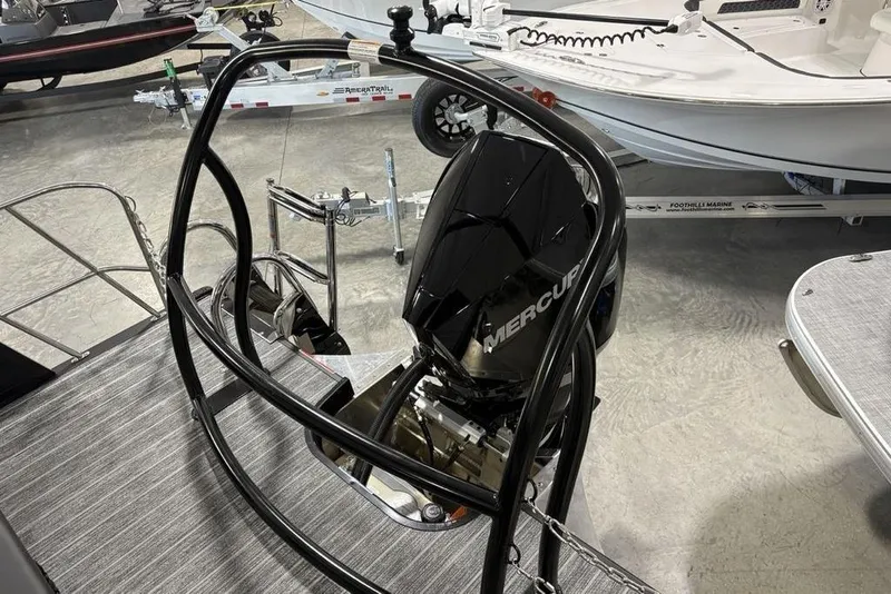 Slide: The Image of 2026 Premier 230 Sunsation RL boat with Mercury outboard motor in showroom. - 34