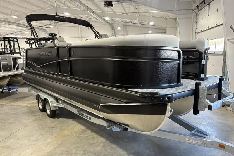 Slide: The Image of 2026 Premier 230 Sunsation RL pontoon boat on trailer in indoor showroom. - 6