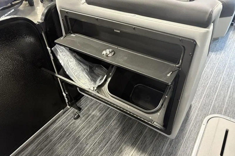 Slide: The Image of Interior storage compartment of 2026 Premier 230 Sunsation RL boat, featuring a built-in trash bin. - 9