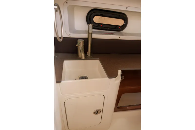 Slide: The Image of Sea Ray boat interior sink with faucet and storage compartment. - 11