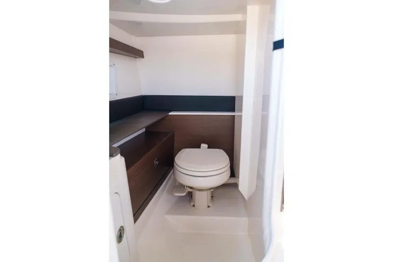 Slide: The Image of Compact Sea Ray boat bathroom with toilet and wooden cabinetry. - 12