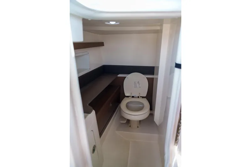 Slide: The Image of Sea Ray boat interior with compact marine toilet and storage shelves. - 13