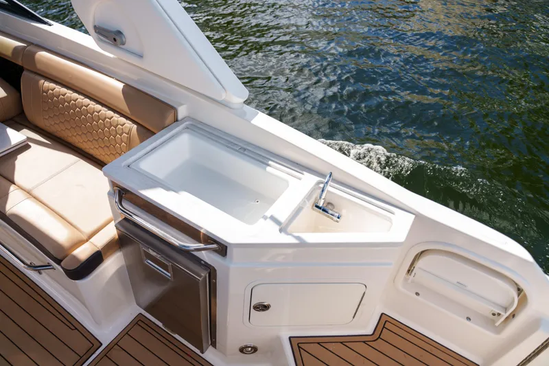 Slide: The Image of Luxurious Sea Ray boat interior with sink, seating, and water view. - 17