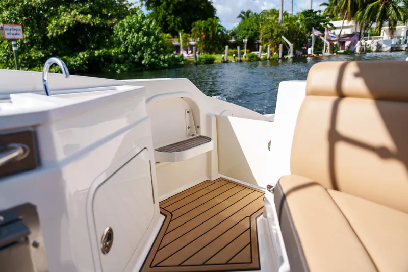 Slide: The Image of Interior view of a Sea Ray boat with tan seating and wooden flooring. - 18