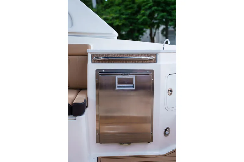 Slide: The Image of Stainless steel refrigerator on a Sea Ray boat with brown seating and white paneling. - 20