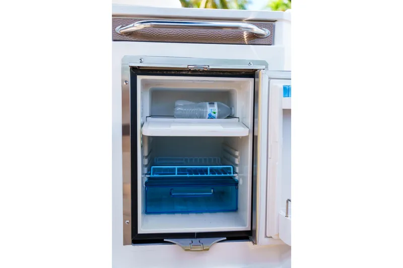 Slide: The Image of Open mini fridge on Sea Ray boat with water bottle inside. - 21