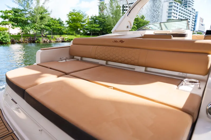Slide: The Image of Luxurious Sea Ray boat with tan leather seating, docked near lush greenery. - 22