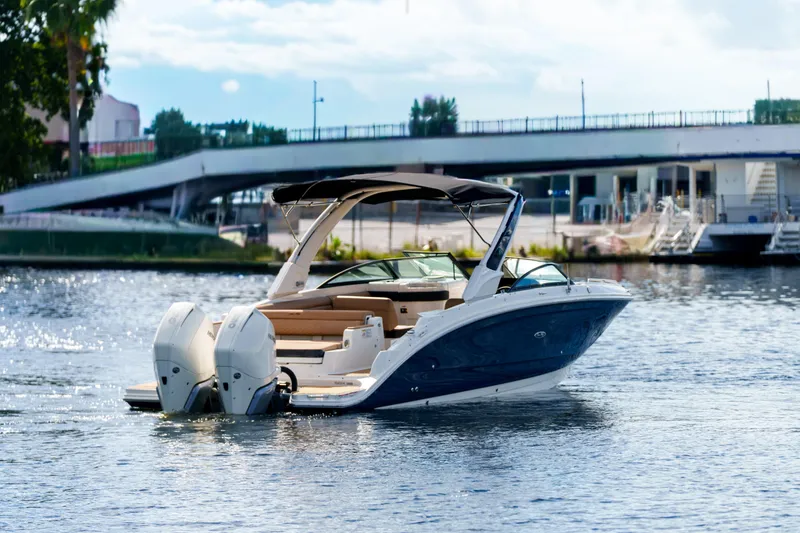 Slide: The Image of Luxury Sea Ray boat cruising on a sunny day near a bridge. - 3