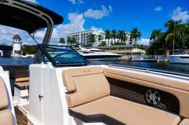 Slide: The Image of Luxurious Sea Ray boat interior with waterfront view, palm trees, and blue sky. - 30