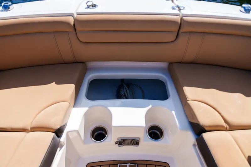 Slide: The Image of Interior view of a Sea Ray boat with tan seating and cup holders. - 34