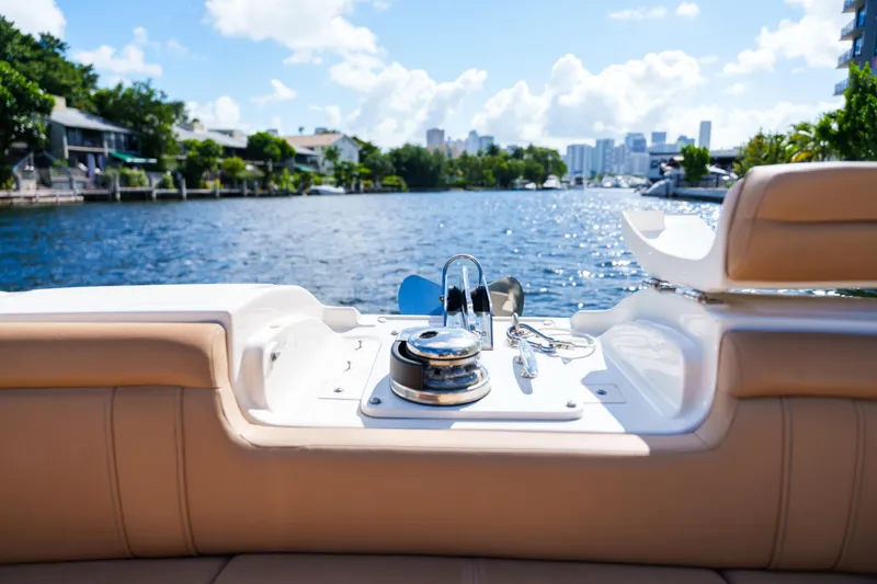 Slide: The Image of Luxury Sea Ray boat interior with waterfront view, featuring plush seating and sunny skies. - 35