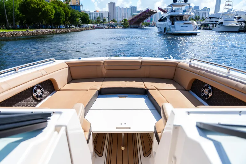 Slide: The Image of Luxurious Sea Ray boat interior with tan seating, cruising in a scenic marina. - 36