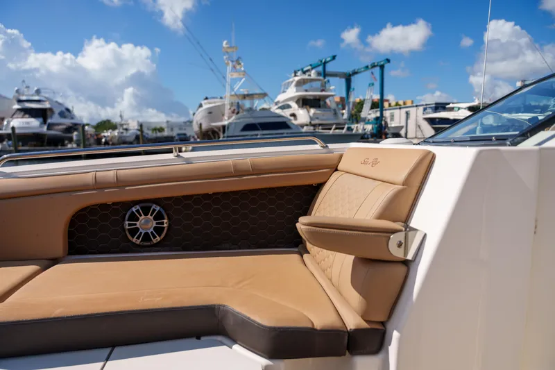 Slide: The Image of Luxurious Sea Ray boat interior with tan leather seating at a marina. - 38