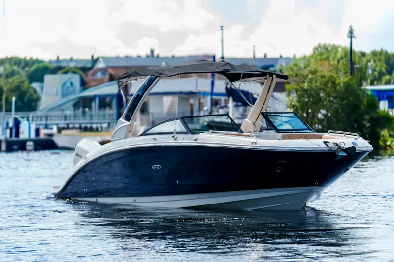 Slide: The Image of Luxury Sea Ray boat cruising on a calm river near a marina. - 4