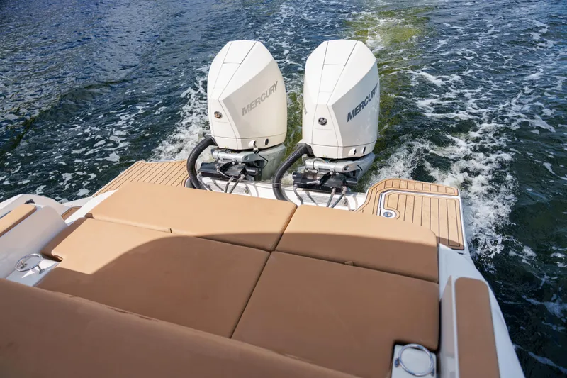 Slide: The Image of Sea Ray boat with dual Mercury outboard engines cruising on water. - 44