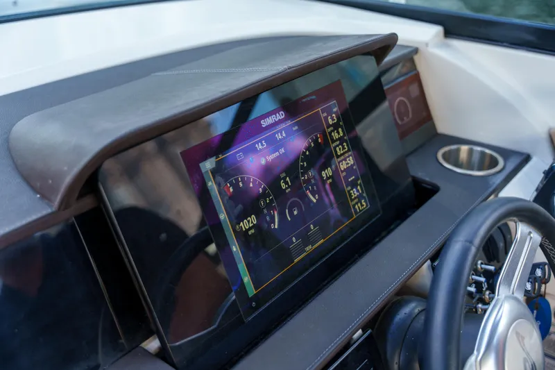 Slide: The Image of Simrad display on Sea Ray boat dashboard with steering wheel and cup holder. - 45