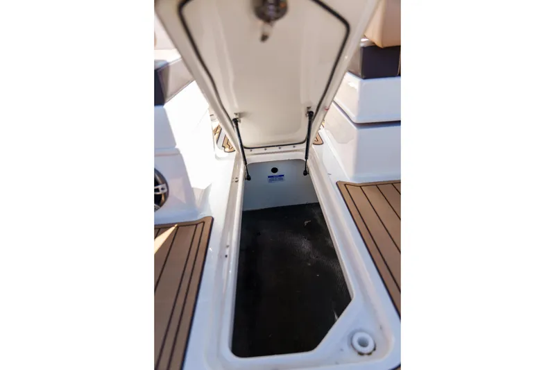 Slide: The Image of Open storage compartment on a Sea Ray boat with teak flooring. - 47