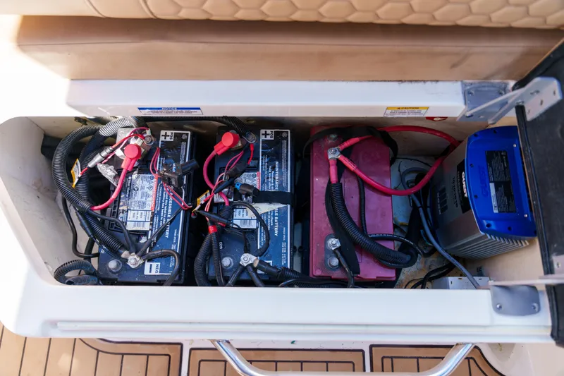 Slide: The Image of Sea Ray boat battery compartment with multiple batteries and wiring. - 48