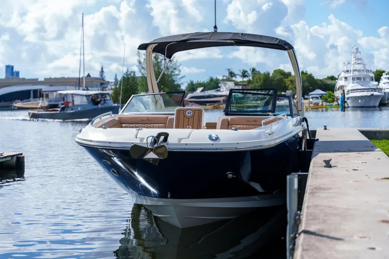 Slide: The Image of Sea Ray boat docked at marina under blue sky with clouds. - 5