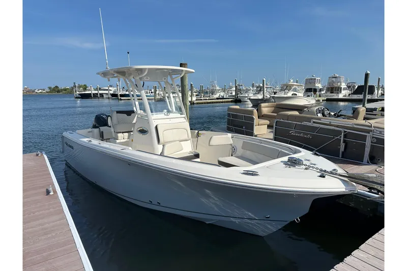 The Image of 2023 Sailfish 241 CC boat docked at marina under clear blue sky. - 0