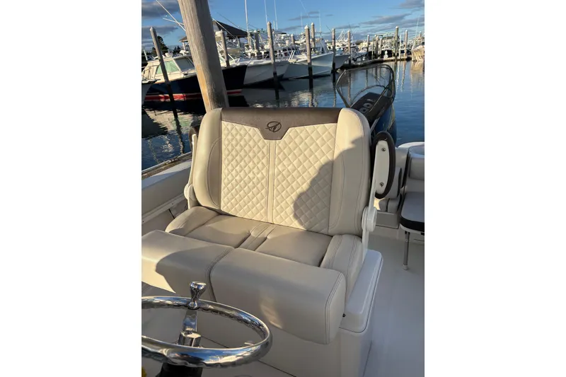 Slide: The Image of Luxurious seating on 2023 Sailfish 241 CC boat at marina. - 2