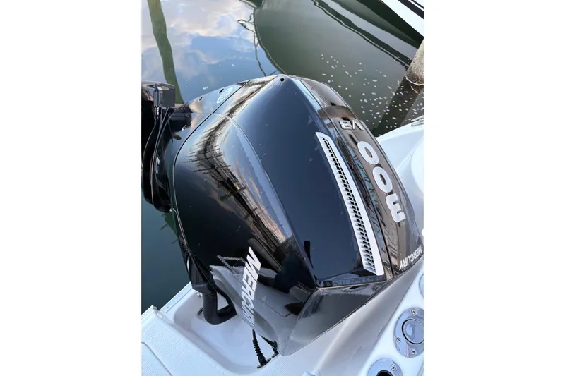 Slide: The Image of Mercury 300 V8 outboard engine on 2023 Sailfish 241 CC boat, docked by water. - 4