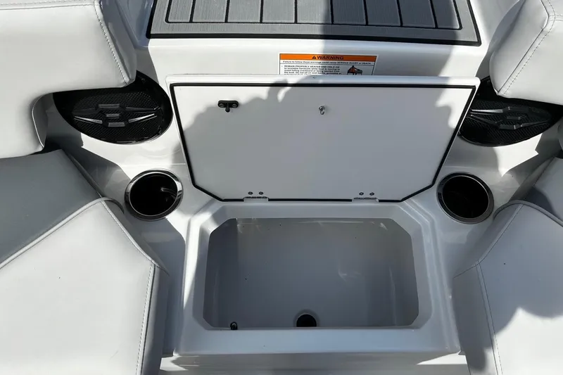 Slide: The Image of 2026 Starcraft SVX 191 OB boat interior with storage compartment and cup holders. - 15