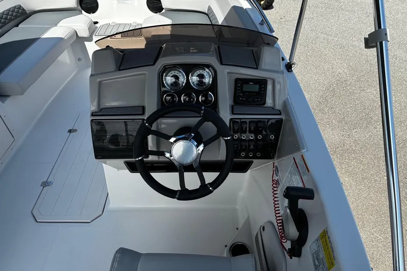 Slide: The Image of 2026 Starcraft SVX 191 OB boat dashboard with steering wheel and control panel. - 5