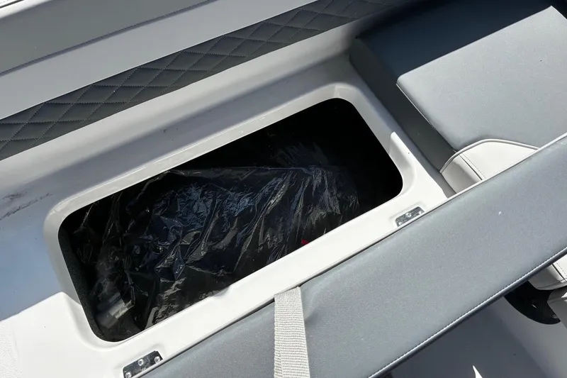 Slide: The Image of Storage compartment in 2026 Starcraft SVX 191 OB boat, featuring cushioned seating. - 8