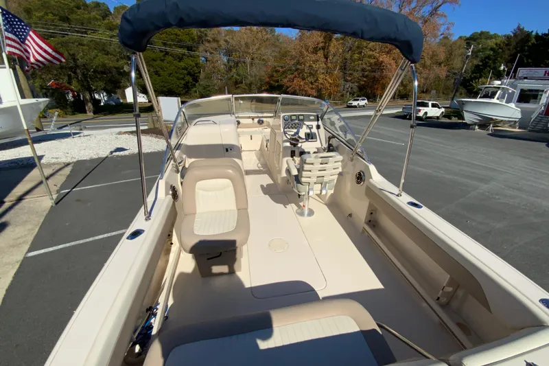 Slide: The Image of 2014 Grady-White Freedom 225 boat interior with seating and steering console. - 10