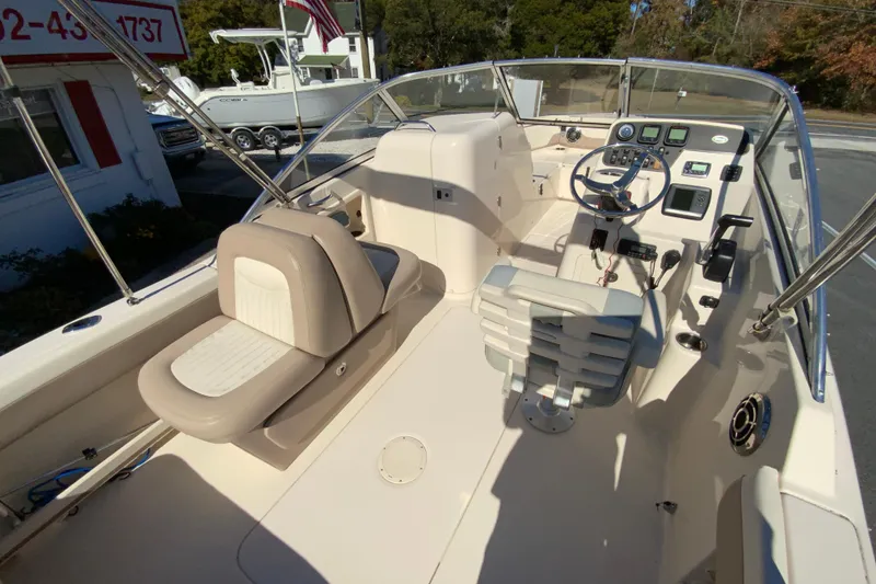 Slide: The Image of 2014 Grady-White Freedom 225 boat interior with steering console and seating. - 11