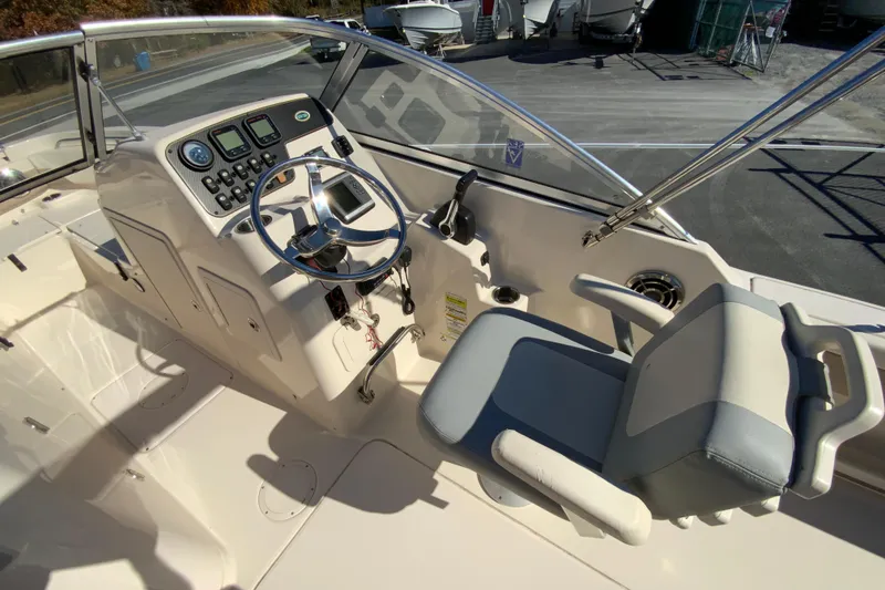 Slide: The Image of 2014 Grady-White Freedom 225 boat cockpit with steering wheel and control panel. - 12