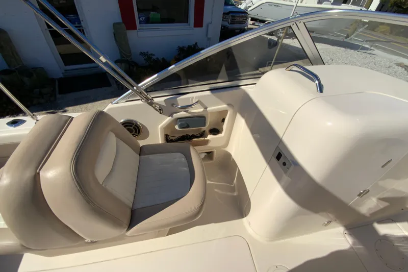 Slide: The Image of 2014 Grady-White Freedom 225 boat interior with beige seating and console. - 14