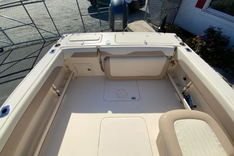 Slide: The Image of 2014 Grady-White Freedom 225 boat interior with seating and storage compartments. - 17