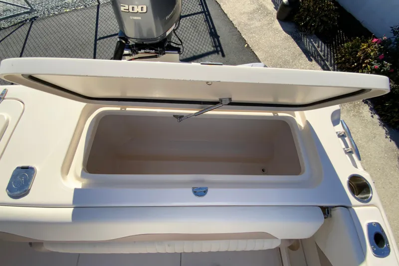 Slide: The Image of 2014 Grady-White Freedom 225 boat with open storage compartment and Yamaha 200 engine. - 18