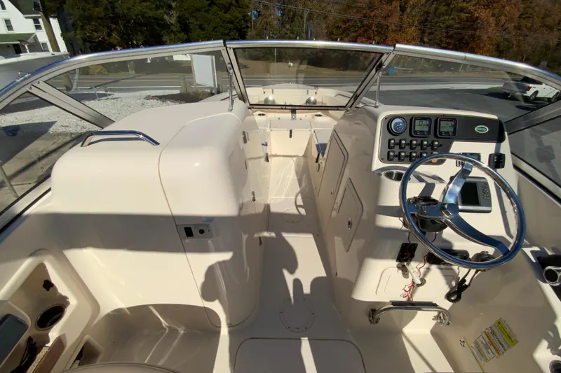 Slide: The Image of 2014 Grady-White Freedom 225 boat interior with steering wheel and control panel. - 20