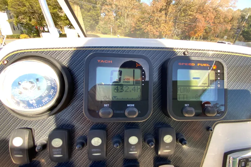 Slide: The Image of Dashboard of a 2014 Grady-White Freedom 225 boat with gauges and controls. - 26