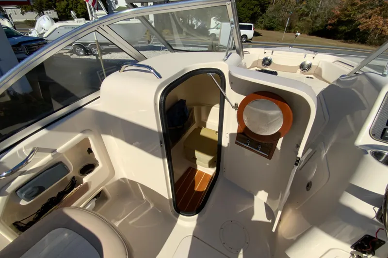 Slide: The Image of 2014 Grady-White Freedom 225 boat interior with open cabin door and seating area. - 27
