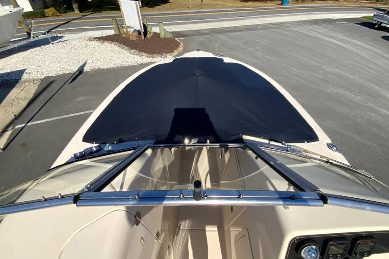 Slide: The Image of 2014 Grady-White Freedom 225 boat with covered bow, parked on pavement. - 29